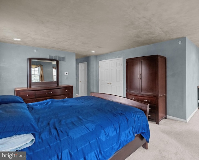 bedroom featuring light carpet, baseboards, and visible vents