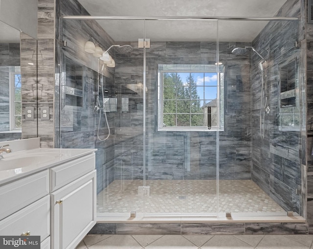 full bathroom featuring tile patterned flooring, vanity, and a stall shower