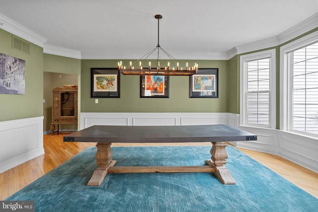 recreation room featuring visible vents, an inviting chandelier, crown molding, and wood finished floors