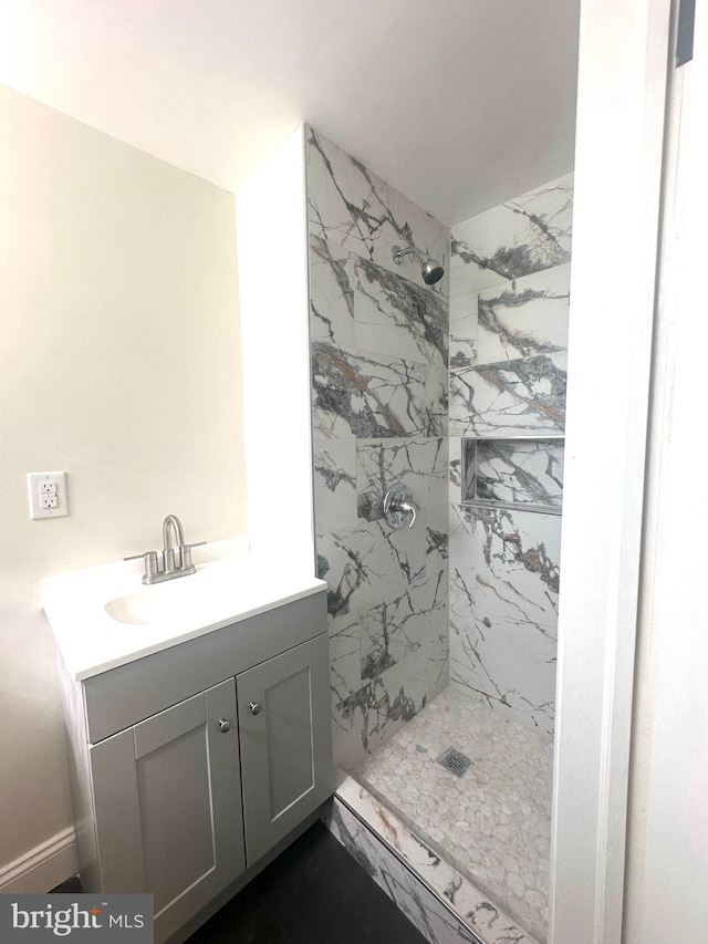 bathroom featuring a shower stall and vanity