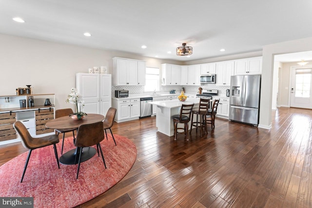 dining space featuring recessed lighting and dark wood finished floors