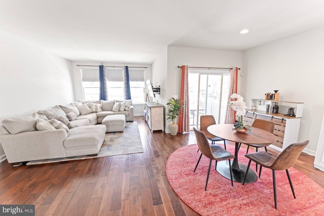 dining area featuring dark wood-type flooring, recessed lighting, baseboards, and a healthy amount of sunlight