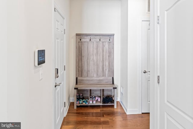 mudroom featuring baseboards and wood finished floors