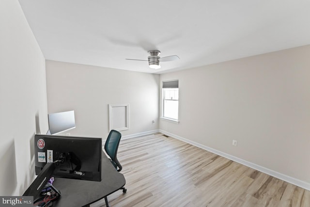 office space with baseboards, a ceiling fan, and wood finished floors
