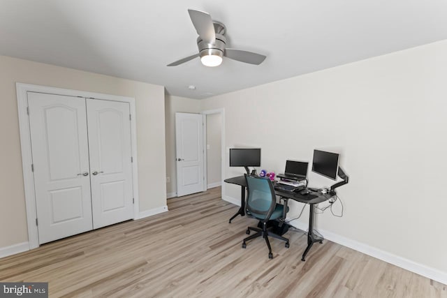 office space featuring baseboards, ceiling fan, and wood finished floors
