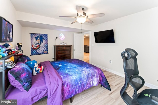 bedroom with baseboards, ceiling fan, and wood finished floors