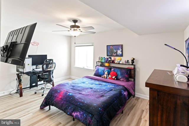 bedroom featuring baseboards, ceiling fan, and wood finished floors