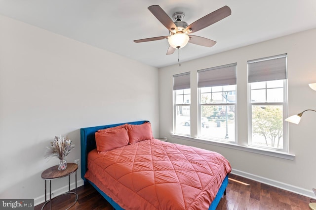 bedroom featuring baseboards, ceiling fan, and wood finished floors