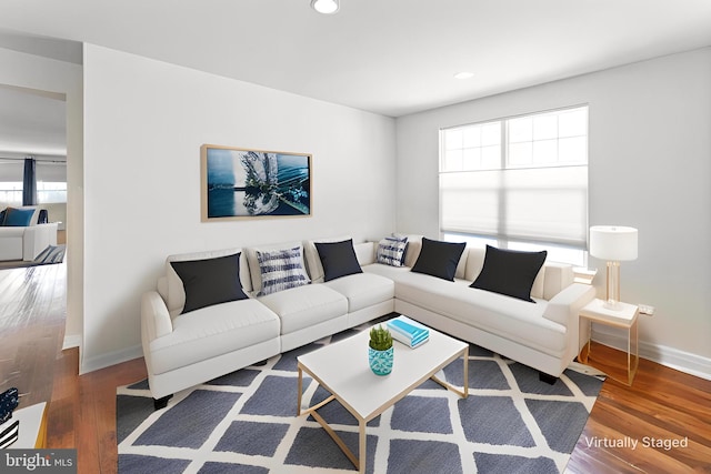 living room with baseboards, recessed lighting, and wood finished floors
