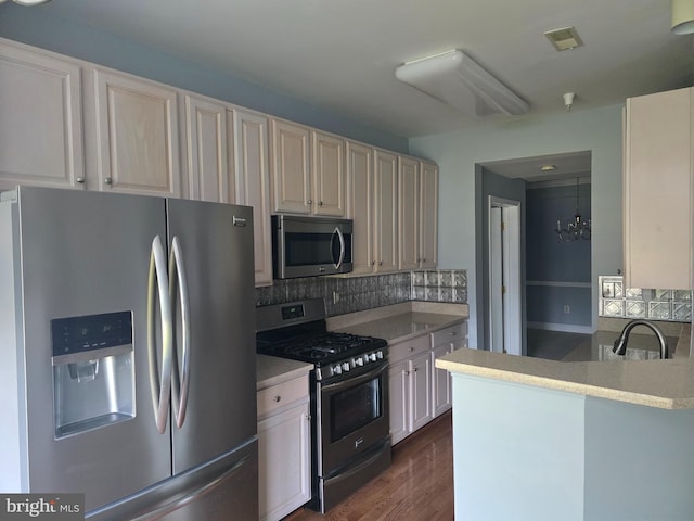 2100 Ganton Grn Unit B-104, Woodstock, MD 21163 - kitchen with stainless steel appliances, a sink, decorative backsplash, and light countertops