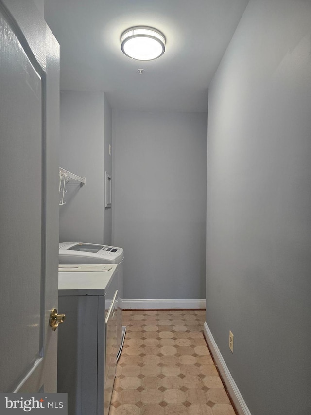 2100 Ganton Grn Unit B-104, Woodstock, MD 21163 - laundry room featuring washer and clothes dryer, light floors, and baseboards