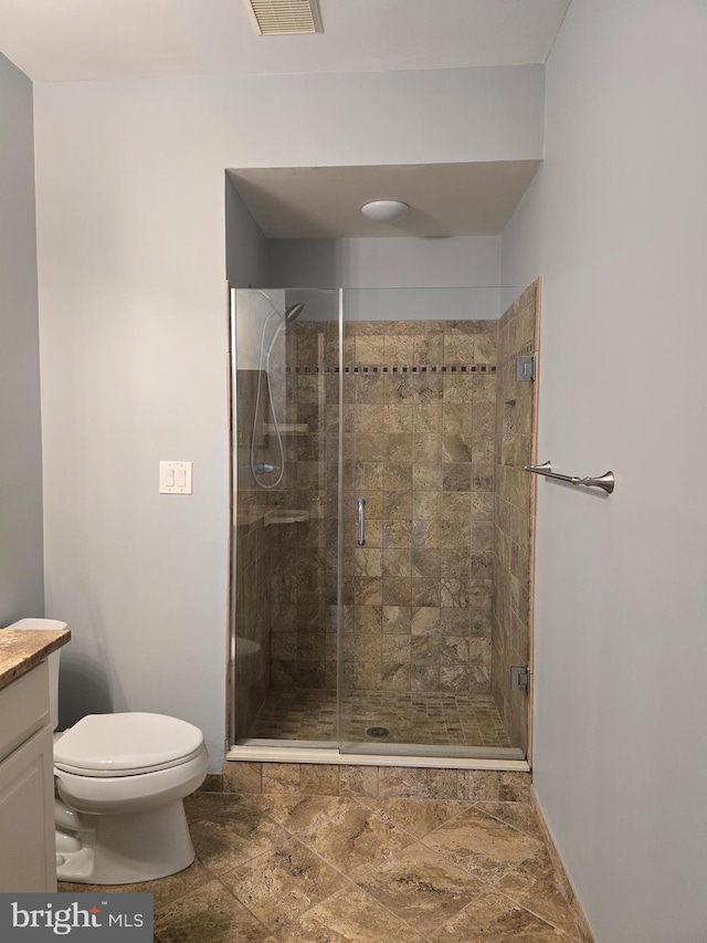 2100 Ganton Grn Unit B-104, Woodstock, MD 21163 - bathroom with toilet, a shower stall, baseboards, and vanity