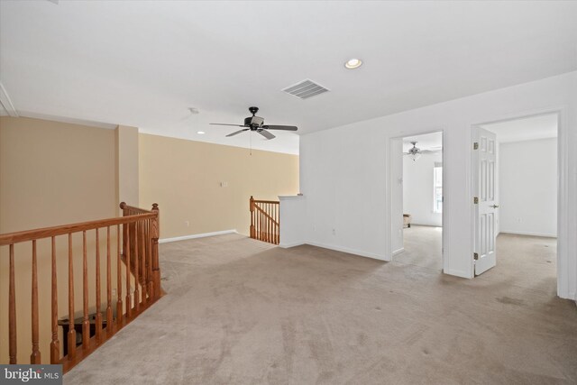 unfurnished living room featuring recessed lighting, a ceiling fan, visible vents, carpet, and baseboards