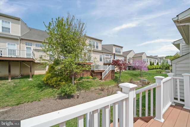 deck with a lawn and a residential view