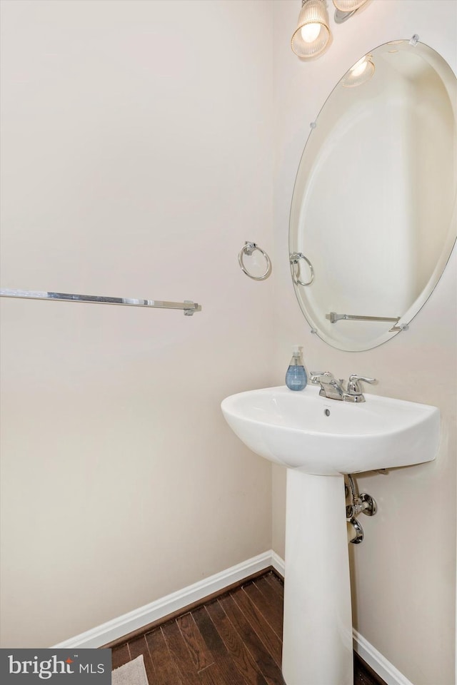 bathroom featuring baseboards and wood finished floors