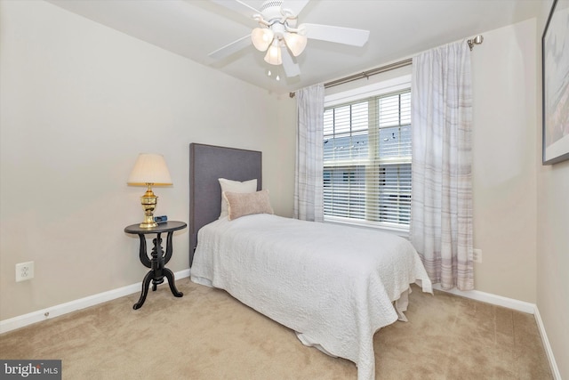 carpeted bedroom featuring a ceiling fan and baseboards