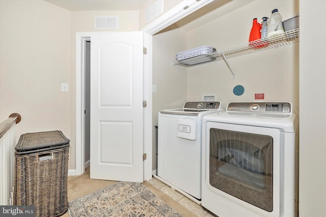 laundry room with visible vents, washing machine and clothes dryer, laundry area, and light carpet