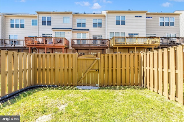 view of yard featuring a fenced backyard and a gate