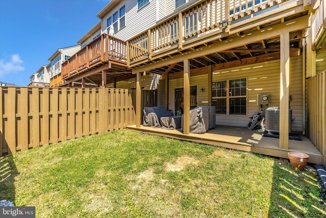 exterior space featuring a deck, a fenced backyard, a yard, and central air condition unit