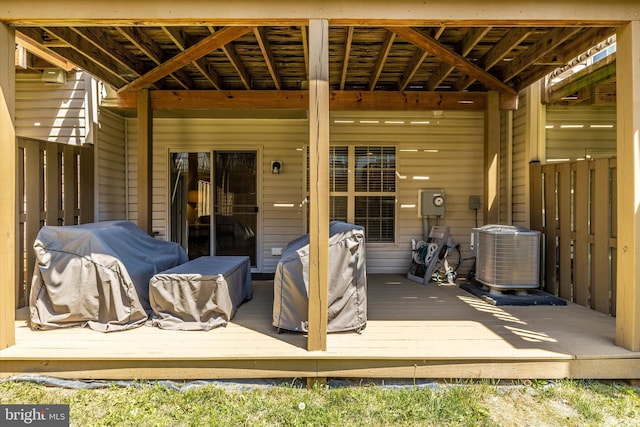 wooden terrace featuring a grill and central AC unit