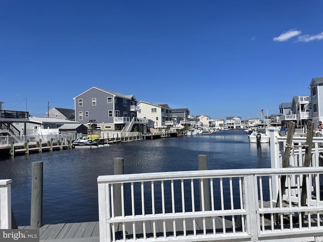 view of dock featuring a water view and a residential view