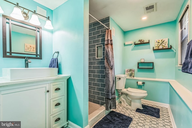 bathroom featuring visible vents, a shower stall, vanity, baseboards, and toilet