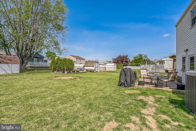 view of yard with fence, a patio, cooling unit, and a residential view