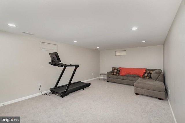 exercise room featuring carpet flooring, visible vents, and baseboards