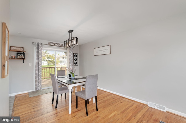dining space featuring visible vents, baseboards, and light wood-type flooring