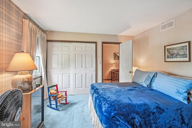 bedroom with carpet and a closet