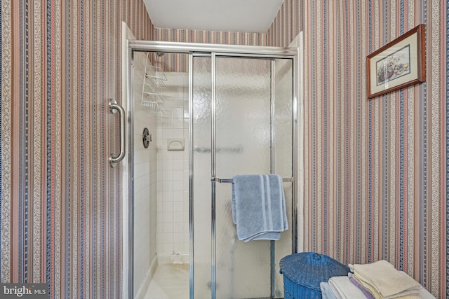 full bathroom with a shower stall and wallpapered walls
