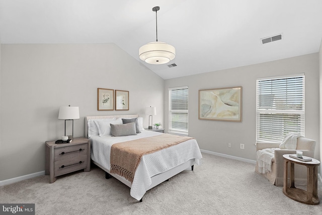 bedroom with vaulted ceiling, multiple windows, and visible vents