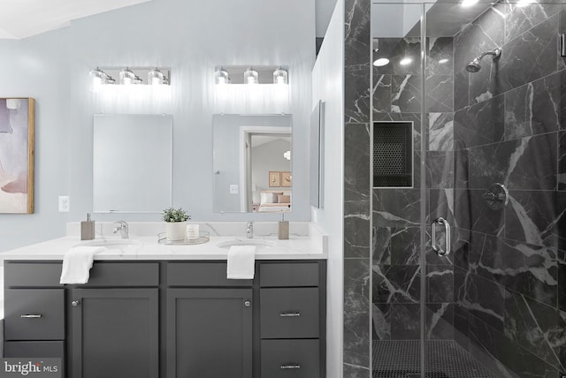 bathroom featuring a sink, a shower stall, and double vanity