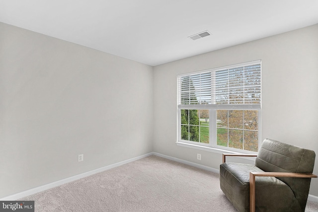 living area with visible vents, baseboards, and carpet floors