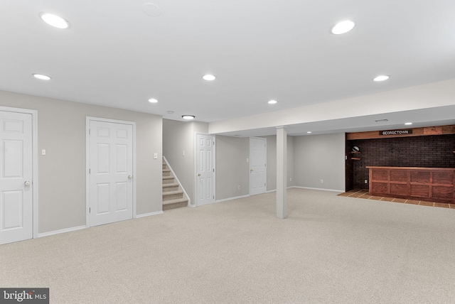 finished below grade area featuring recessed lighting, stairway, baseboards, and carpet floors