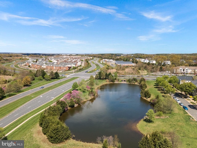 drone / aerial view with a water view and a residential view