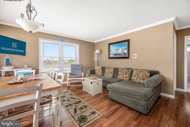 living room with baseboards, ornamental molding, and wood finished floors