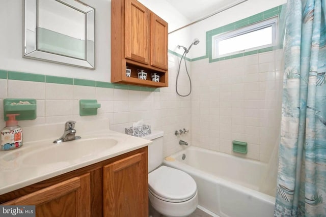 full bathroom with vanity, shower / bathtub combination with curtain, toilet, and tile walls