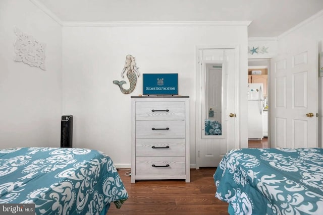 bedroom featuring dark wood-type flooring, freestanding refrigerator, and ornamental molding