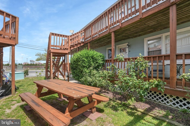 view of yard with stairway and a deck