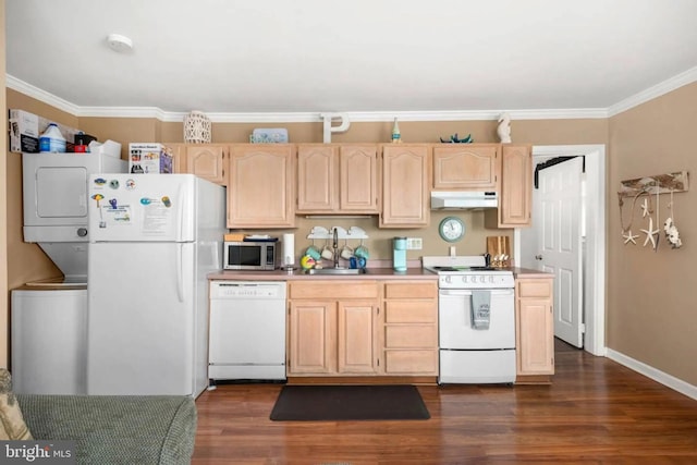 kitchen featuring stacked washing maching and dryer, light brown cabinets, under cabinet range hood, and white appliances