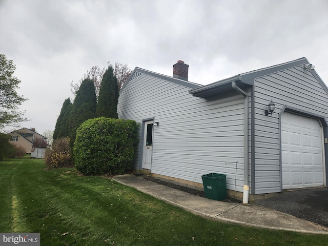 view of side of home with a lawn and a chimney