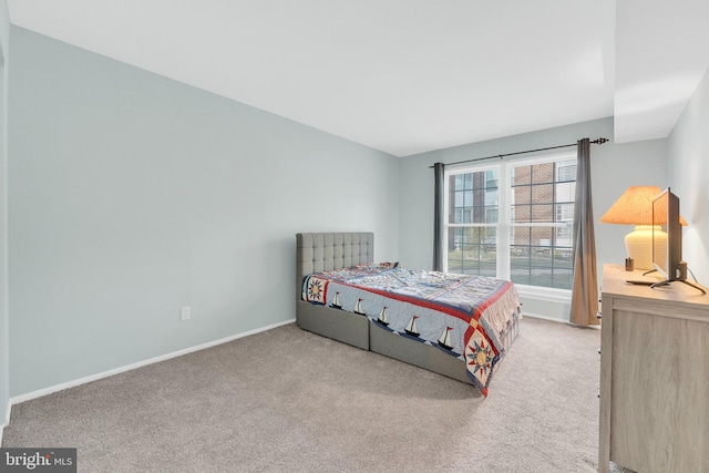 carpeted bedroom featuring baseboards