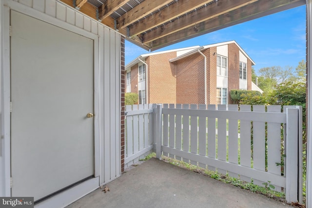 view of property exterior with board and batten siding and fence