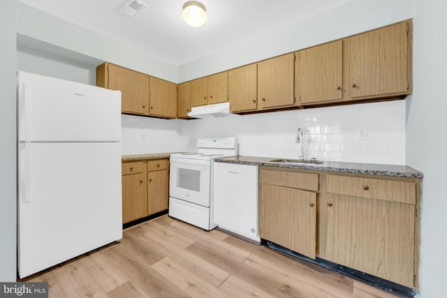 kitchen with a sink, white appliances, visible vents, under cabinet range hood, and light wood-style floors