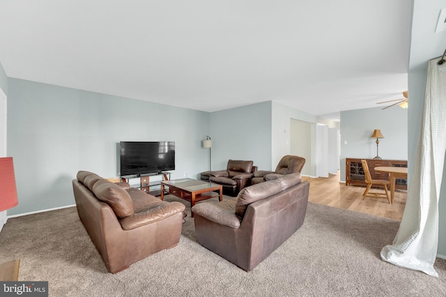 living room with ceiling fan and carpet