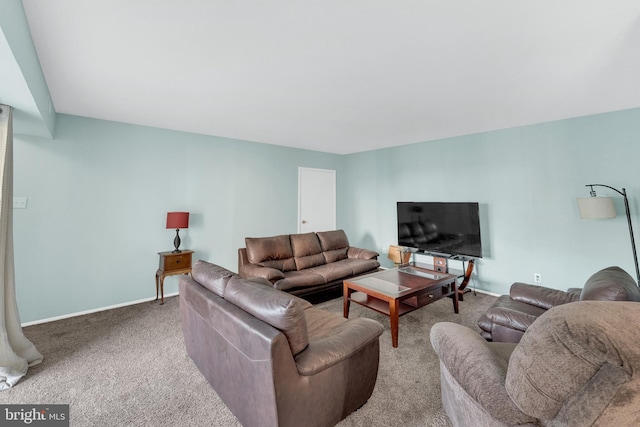living area with baseboards and carpet