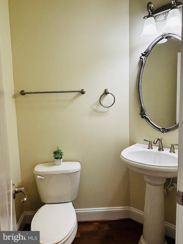 8457 Amanda Pl, Vienna, VA 22180 - bathroom featuring baseboards, toilet, and wood finished floors