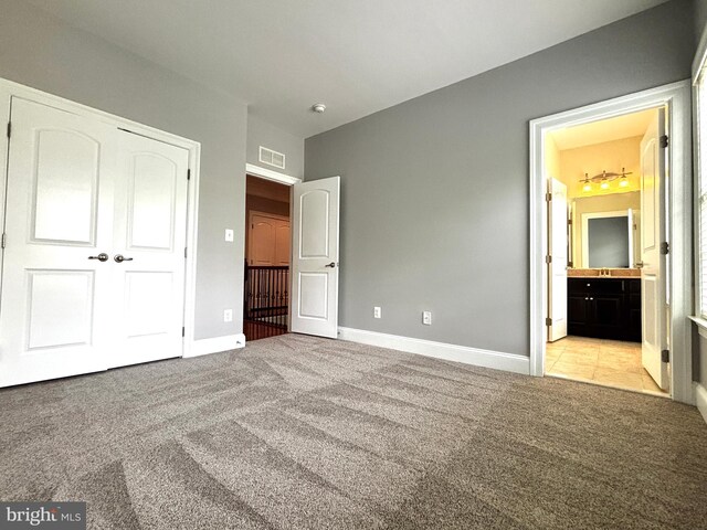 8457 Amanda Pl, Vienna, VA 22180 - unfurnished bedroom with carpet flooring, baseboards, a closet, and connected bathroom