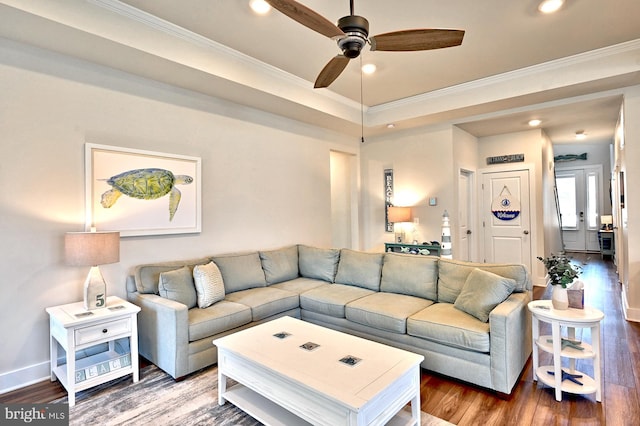 living room with a ceiling fan, ornamental molding, and wood finished floors